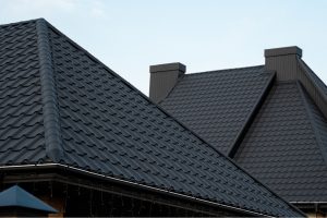 A modern home with black roof tile paint, showcasing the sleek appearance and benefits of using black paint for roof tiles.